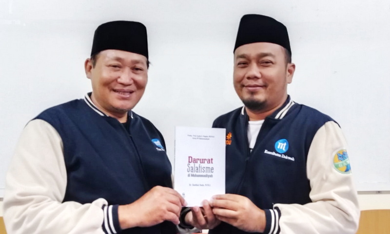 Dr. Sholikh Al Huda (kanan) bersama Wakil Ketua PWM Jawa Timur KH. Dr. Sholihin Fanani, M.MP. menunjukkan buku “Darurat Salafisme di Muhammadiyah”